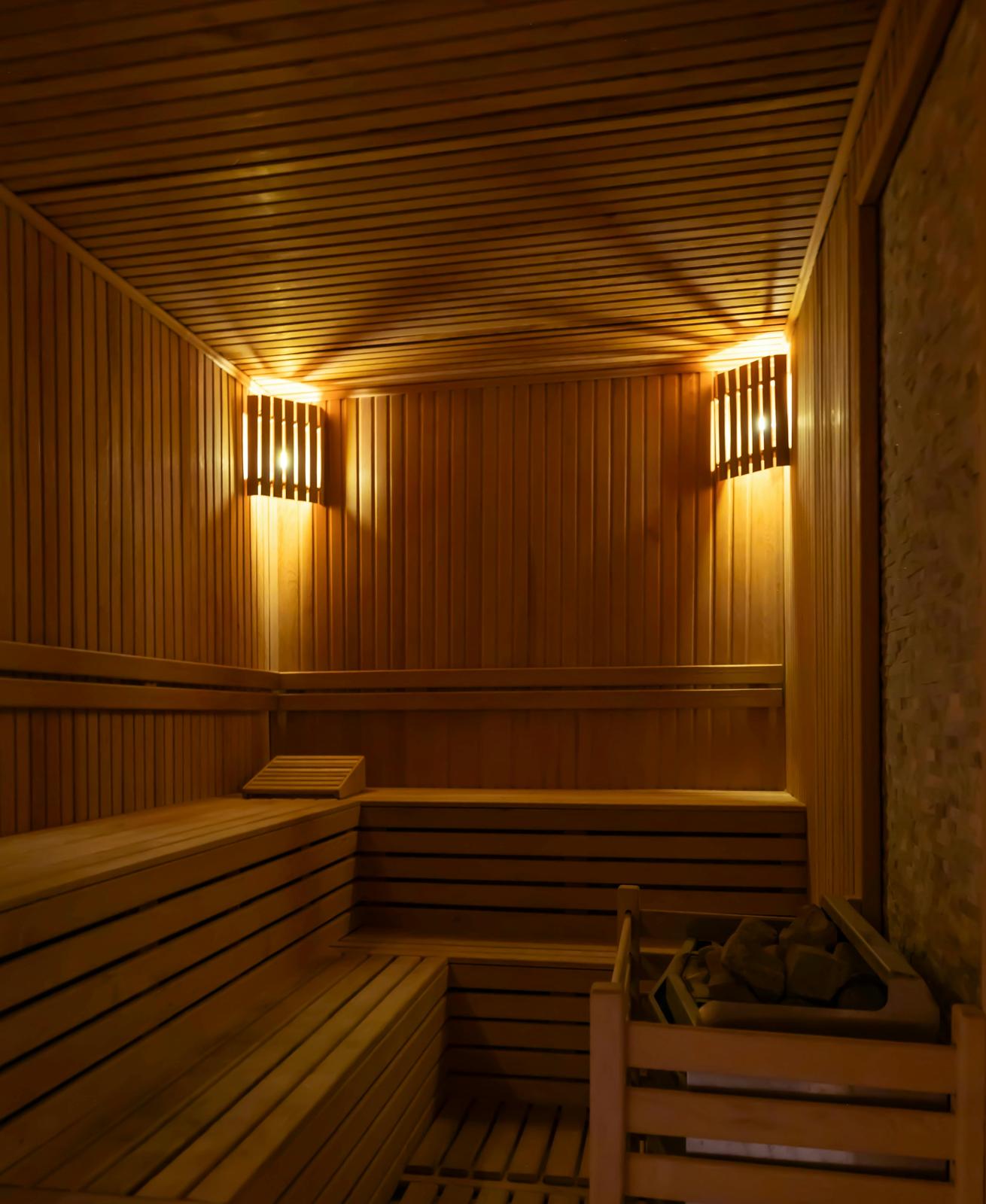 Luxury wooden sauna interior with electric heater and LED accent lighting